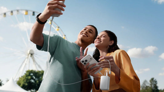 Friends sharing Anker power bank to charge phone